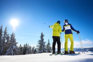 Couple on skies on snowy Gunstock Mountain